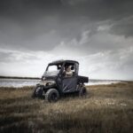 Man riding cart near water.