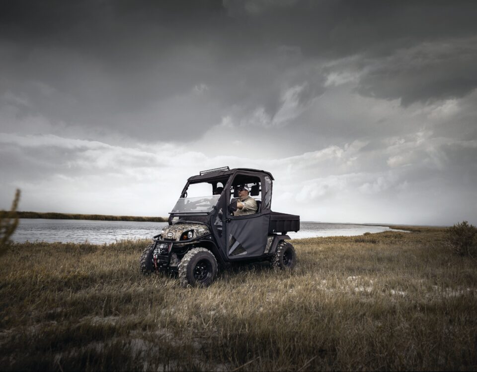 Man riding cart near water.