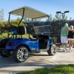 Senior couple leaving parked golf cart to play tennis.