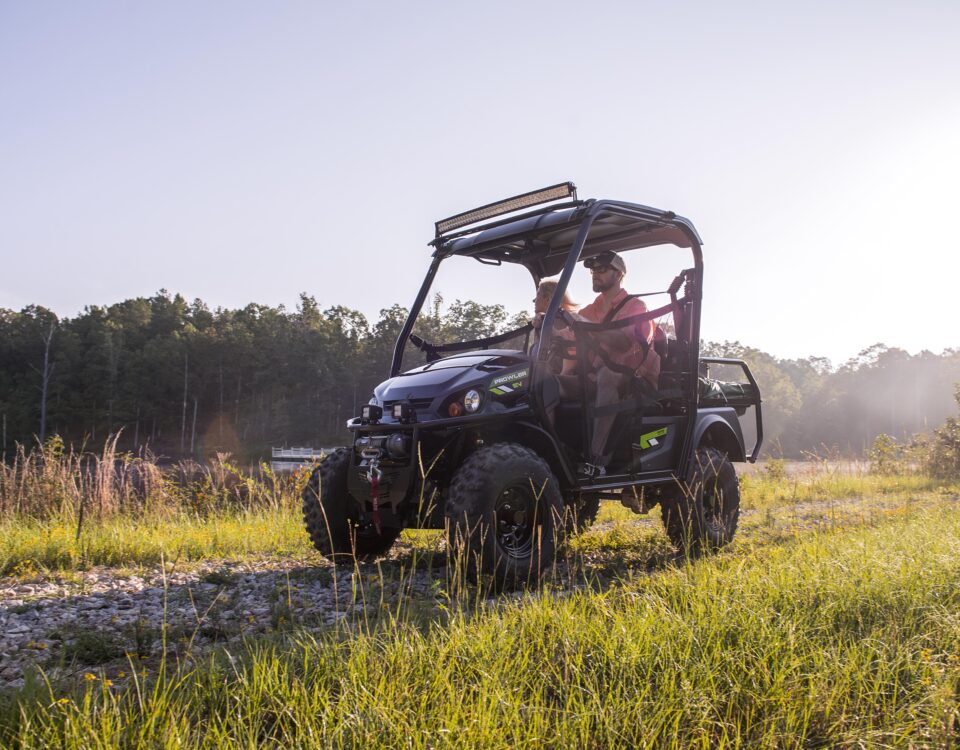 Off road golf cart near a pond.