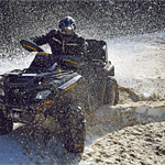 Man riding ATV cart in snow.