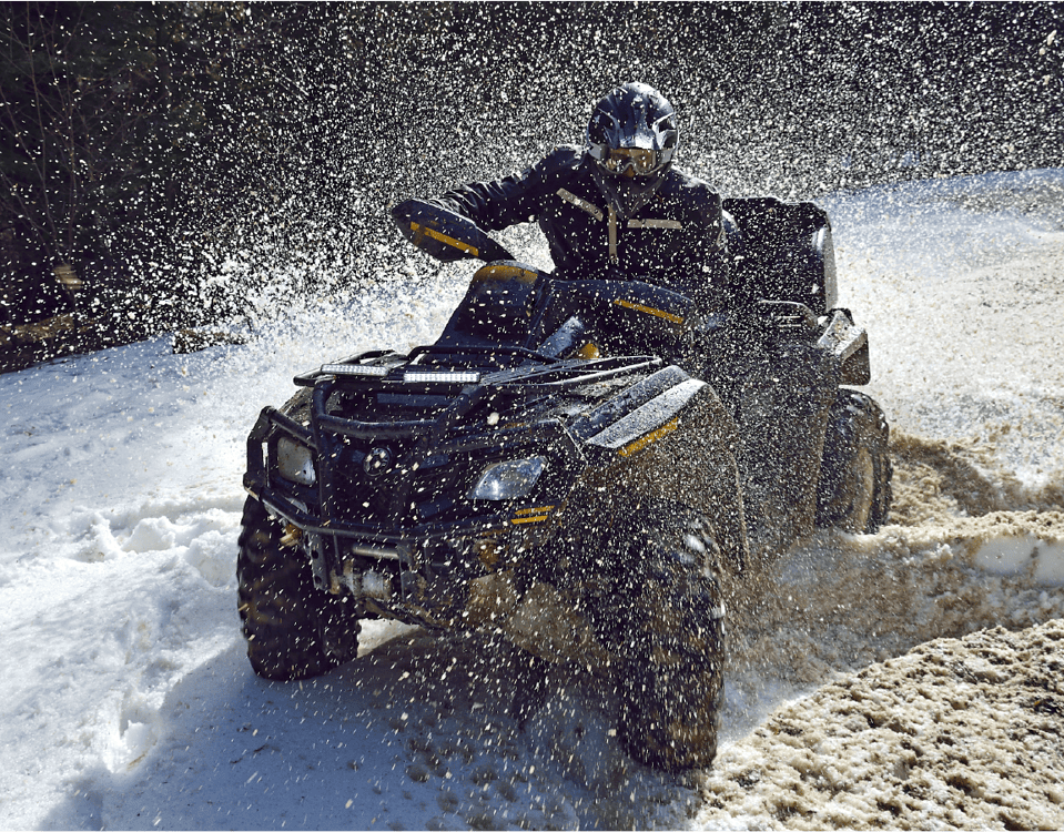 Man riding ATV cart in snow.