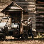 Man using golf cart to do cabin work.