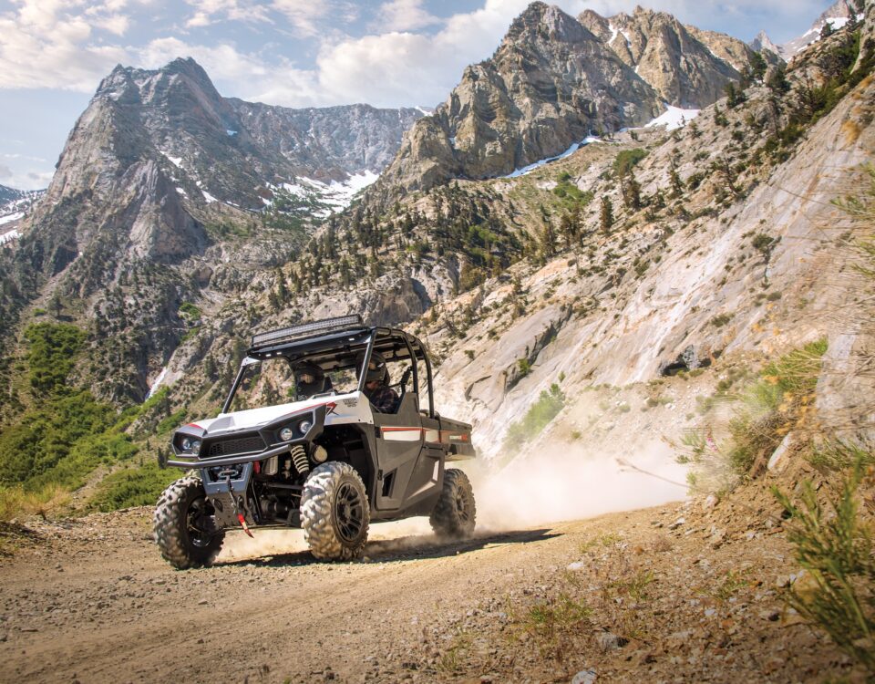 People riding ATV in mountains.