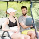 a family riding their golf cart through the woods