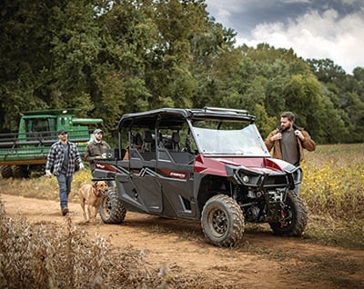 Friends riding ATV in the wild.