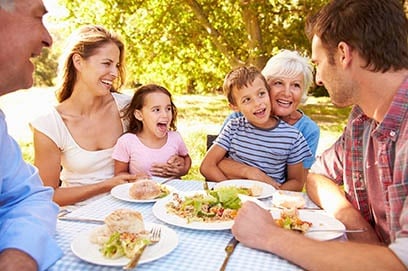 Family enjoying a picnic outdoors.