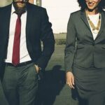 Businessman and business woman walking together.