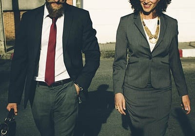 Businessman and business woman walking together.