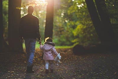 Dad and daughter hiking.