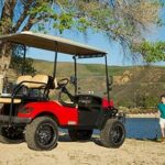 Father and son walking to golf cart.