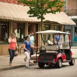 Friends getting ready to ride golf cart.