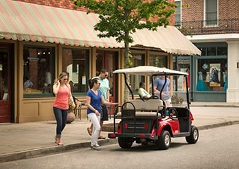 Friends getting ready to ride golf cart.