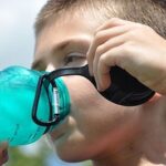 Boy drinking water from water bottle.