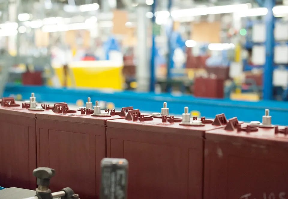 Golf cart batteries on an assembly line