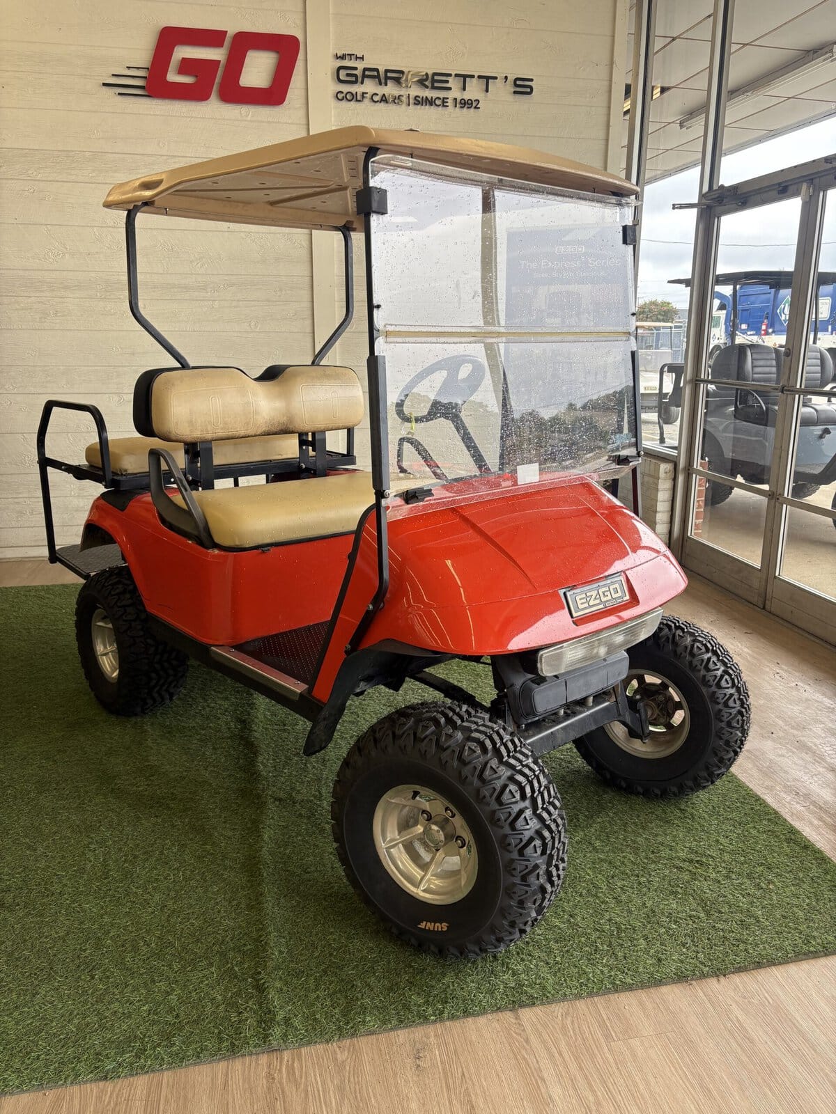 #303 - E-Z-GO TXT 48V Electric - Custom Lifted Electric Red/Orange